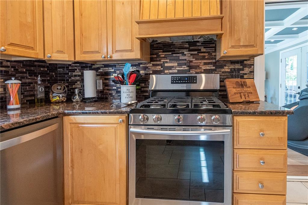 357 Carley Avenue Sharon, PA 16146 - Photo 12 of 32 a kitchen with stainless steel appliances granite countertop a stove and a sink