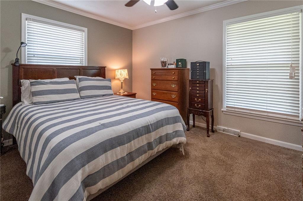 357 Carley Avenue Sharon, PA 16146 - Photo 16 of 32 a bedroom with a bed and a chandelier