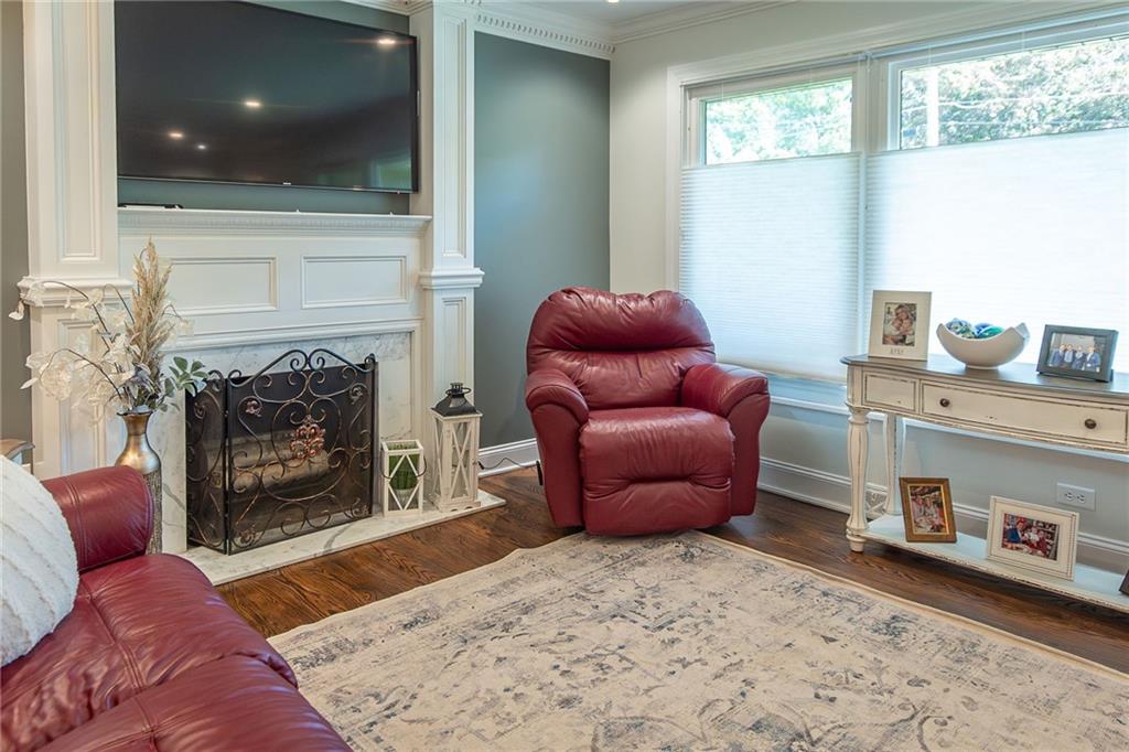 357 Carley Avenue Sharon, PA 16146 - Photo 5 of 32 a living room with furniture a fireplace and a floor to ceiling window