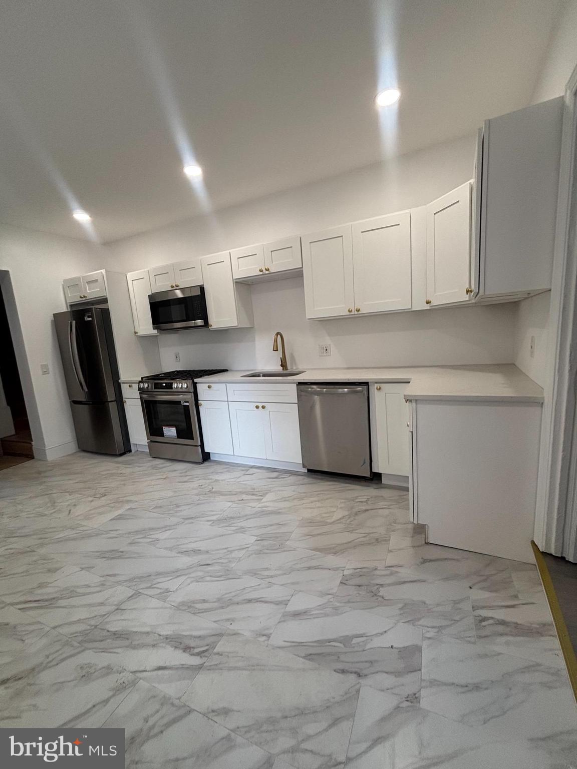 624 Poplar Street Lancaster, PA 17603 - Photo 3 of 25 a view of kitchen with stainless steel appliances granite countertop a stove top oven a sink dishwasher and a refrigerator with wooden floor
