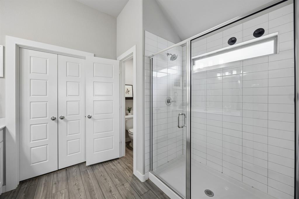 1505 Wayback Drive Celina, TX 75009 - Photo 17 of 25 Modern walk-in shower with clear glass enclosure and white subway tile surround.