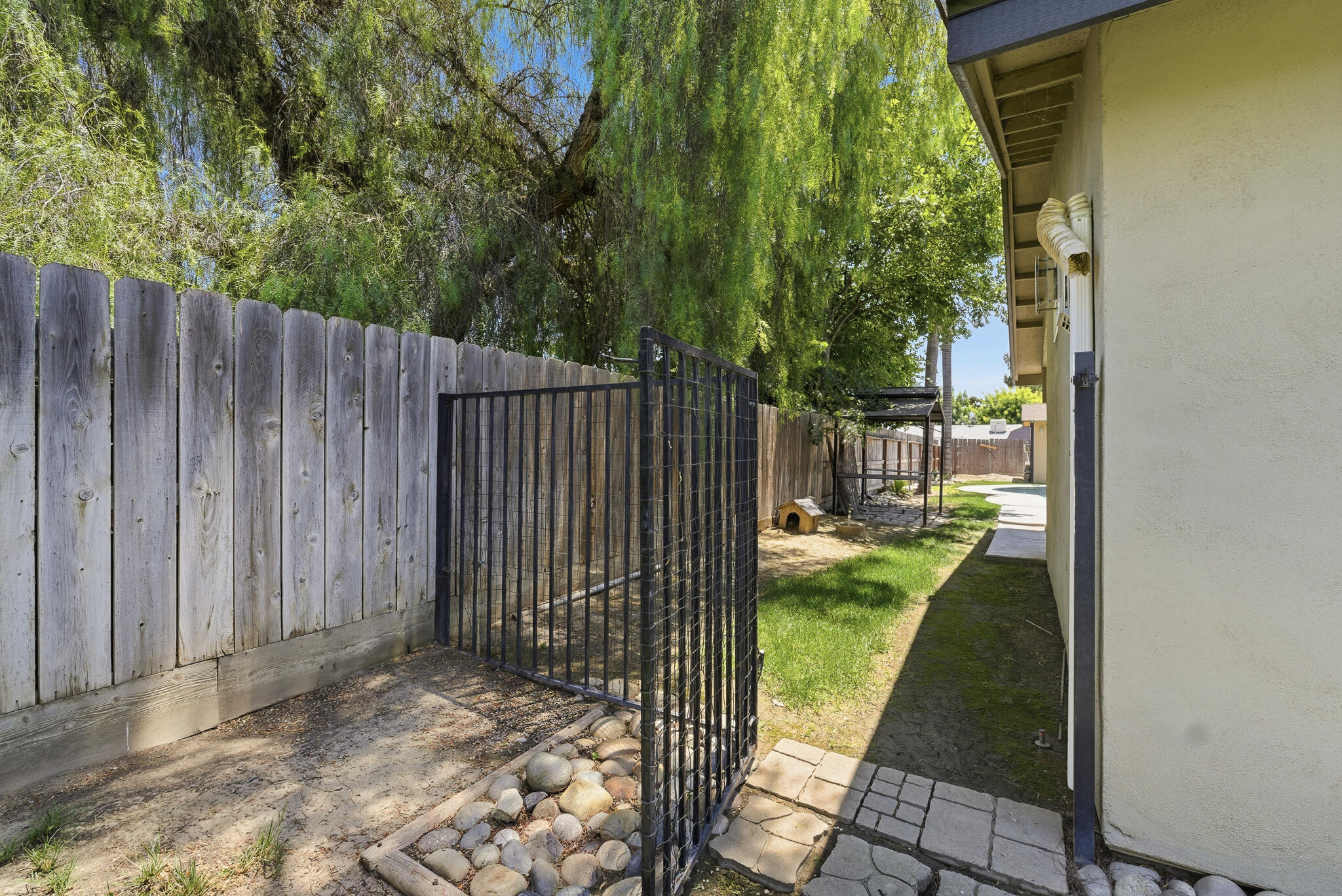 618 Birdsong Court Exeter, CA 93221 - Photo 62 of 62 a view of backyard with wooden fence and a trees