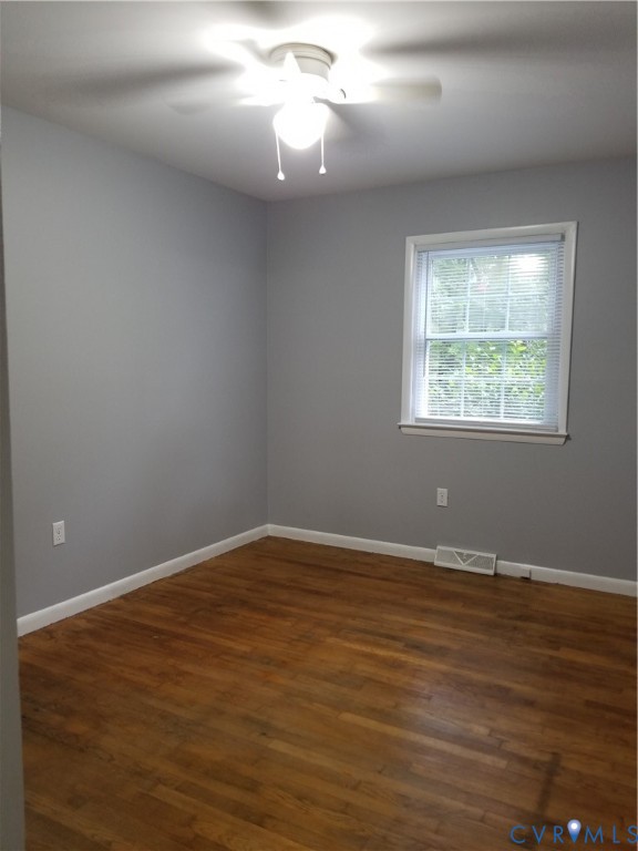 139 Pike Street Gum Spring, VA 23065 - Photo 4 of 11 an empty room with wooden floor and windows