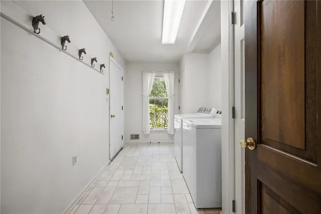 a view of an empty room with windows and closet