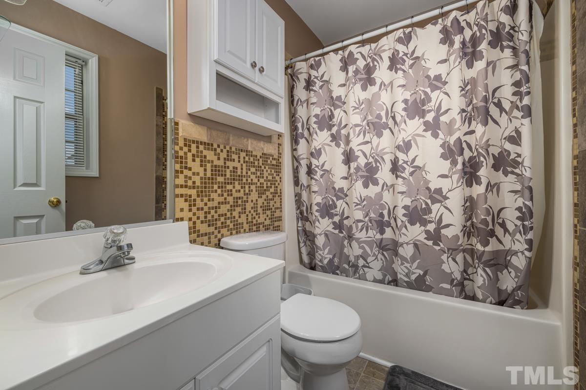 4905 Windproof Way Raleigh, NC 27616 - Photo 29 of 39 a bathroom with a sink toilet and shower