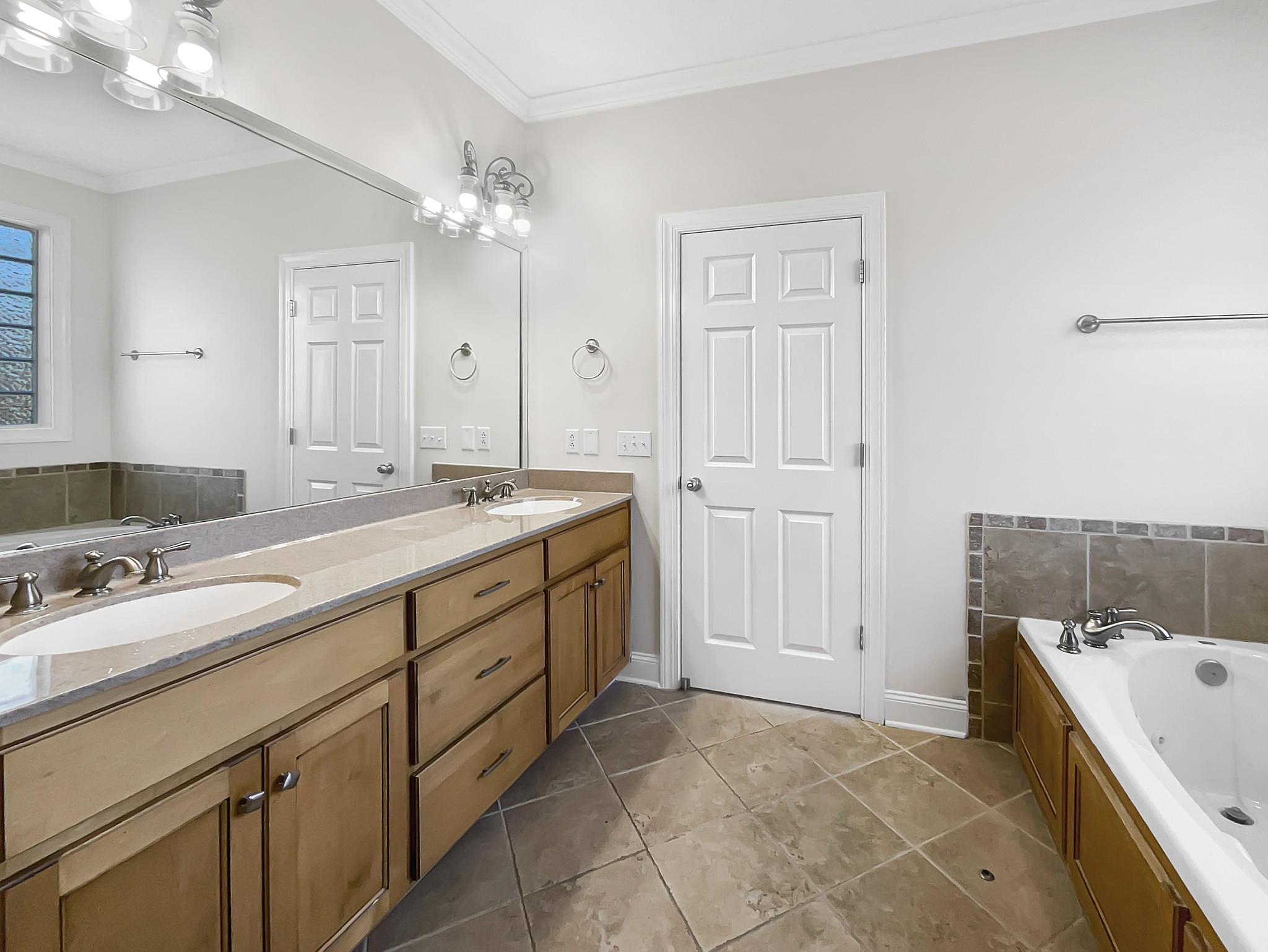 7302 Kempton Court Fairview, TN 37062 - Photo 22 of 28 a spacious bathroom with a bathtub sink and mirror