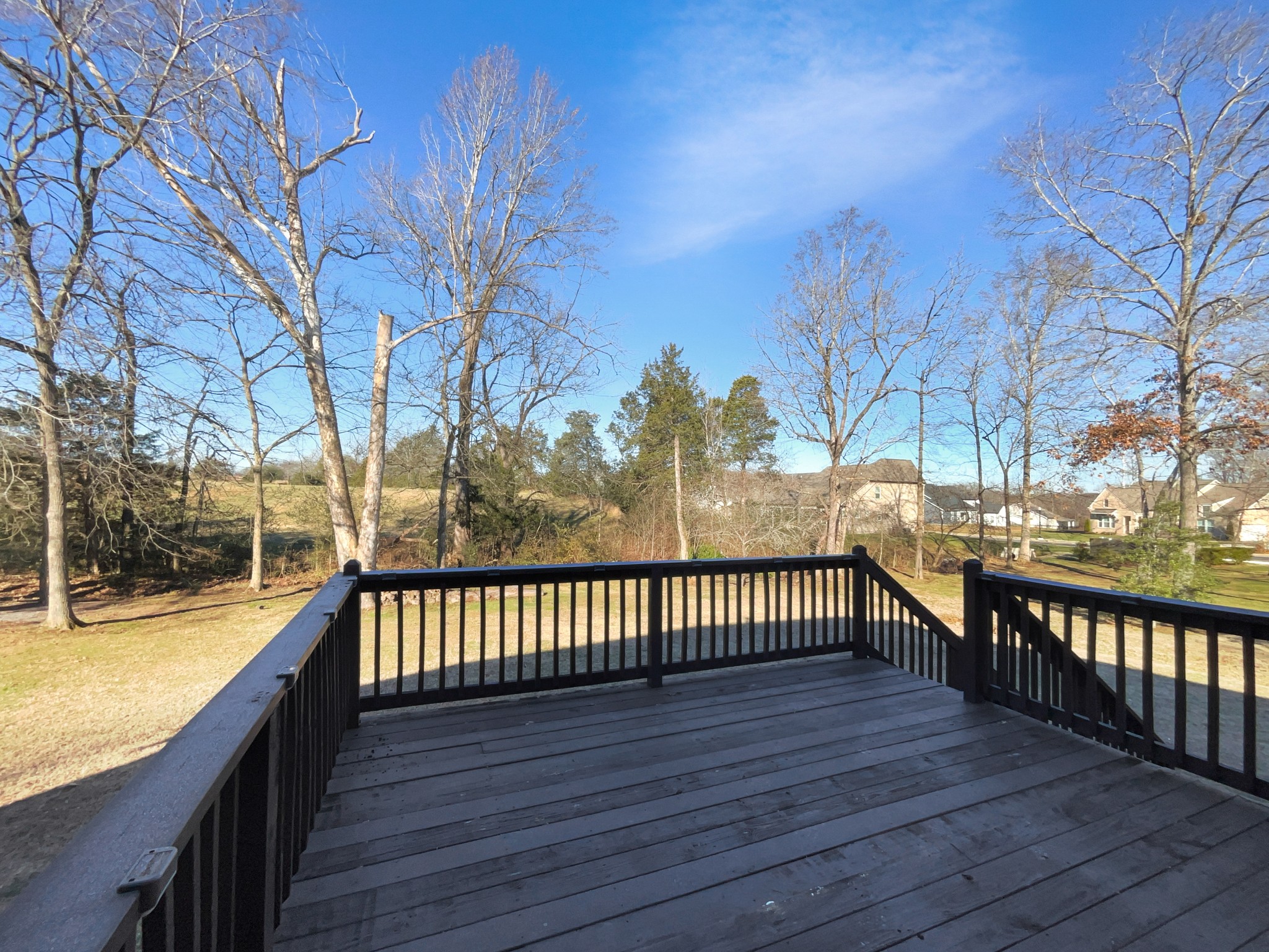 7302 Kempton Court Fairview, TN 37062 - Photo 27 of 28 a view of a patio with wooden floor and iron fence