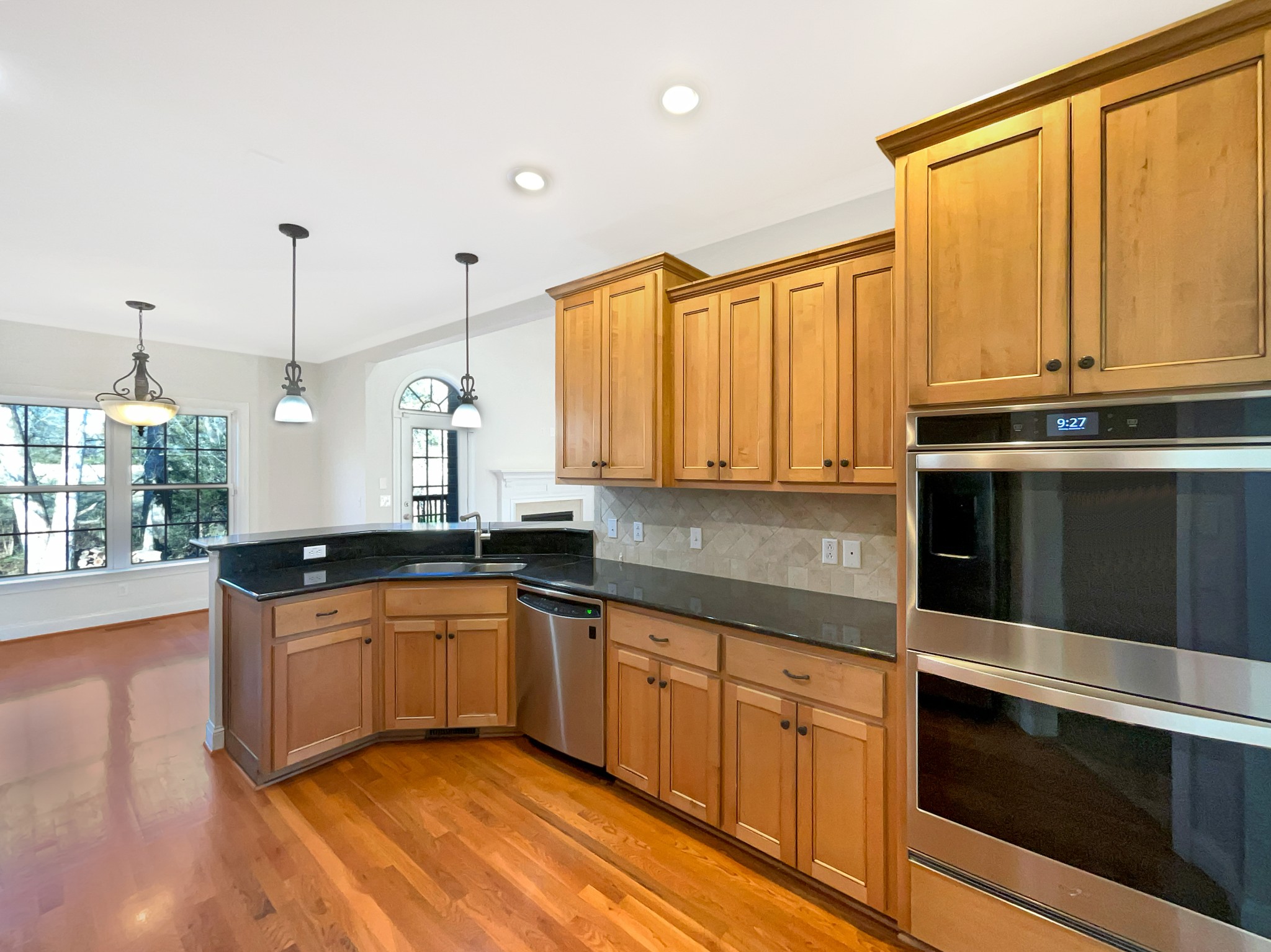 7302 Kempton Court Fairview, TN 37062 - Photo 6 of 28 a kitchen with stainless steel appliances granite countertop a stove a sink and a microwave