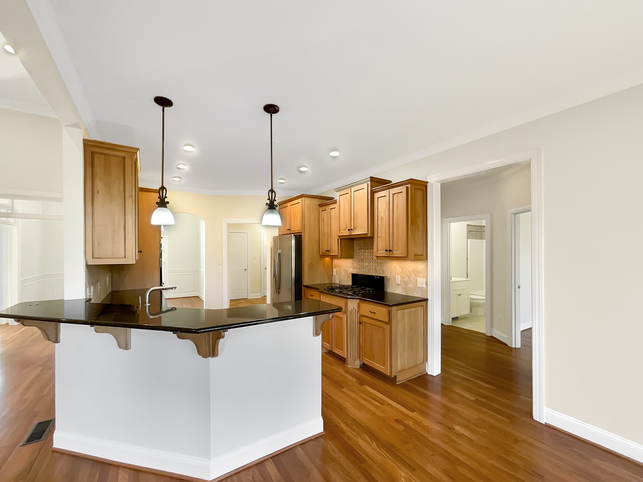 7302 Kempton Court Fairview, TN 37062 - Photo 8 of 28 a kitchen with kitchen island granite countertop a stove and a sink