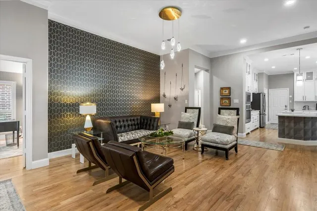 a living room with furniture and wooden floor
