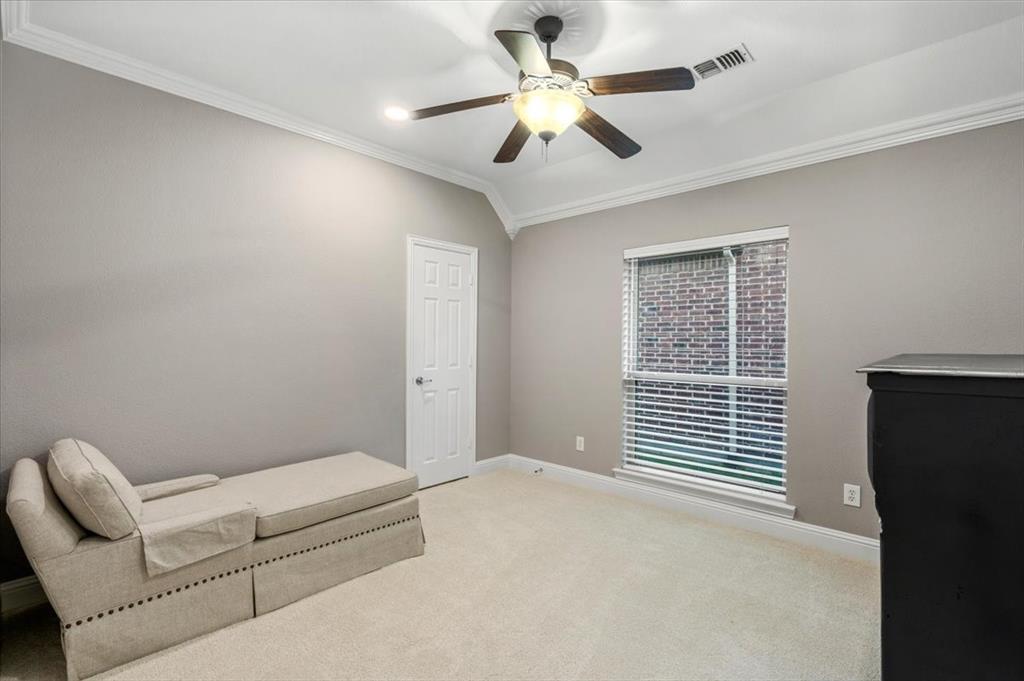 2517 Windsor Castle Way Lewisville, TX 75056 - Photo 19 of 30 a bedroom with a bed and a chandelier