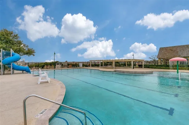 a view of a swimming pool and a yard