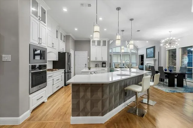 a large kitchen with kitchen island a sink table and chairs