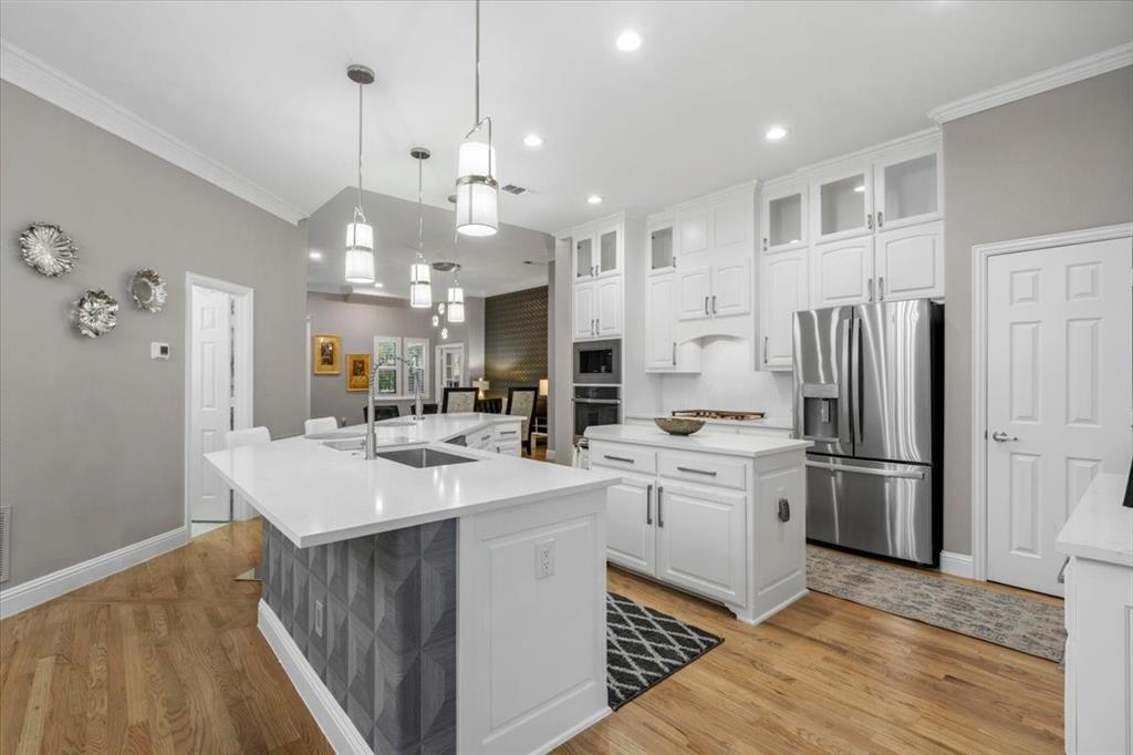 2517 Windsor Castle Way Lewisville, TX 75056 - Photo 5 of 30 a kitchen with kitchen island a sink stainless steel appliances and cabinets