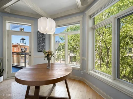 a dining room with furniture window and wooden floor