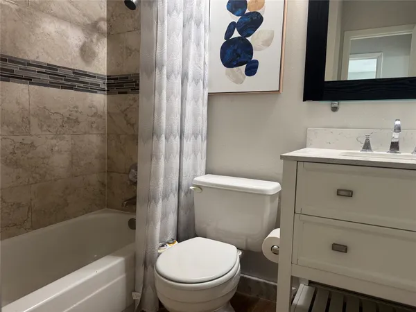 a bathroom with a toilet a sink and bathtub