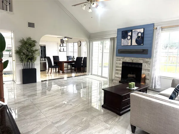 a living room with furniture and a fireplace