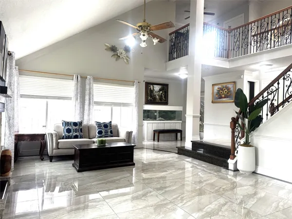a living room with furniture a fireplace and a chandelier