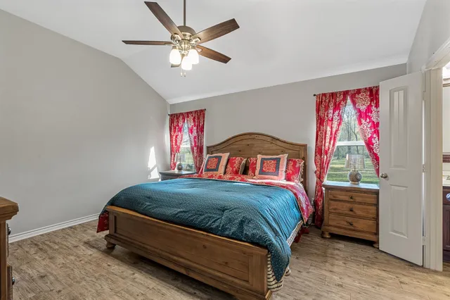 a bedroom with a bed and a chandelier