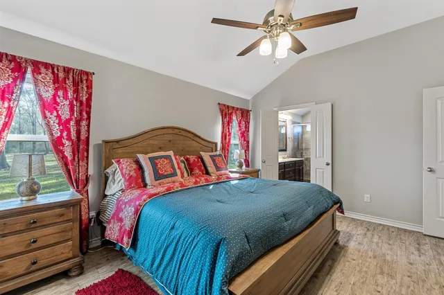 a bedroom with a bed and a chandelier