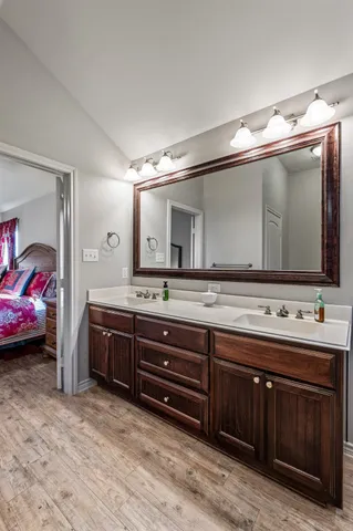 a spacious bathroom with a double vanity sink and a mirror