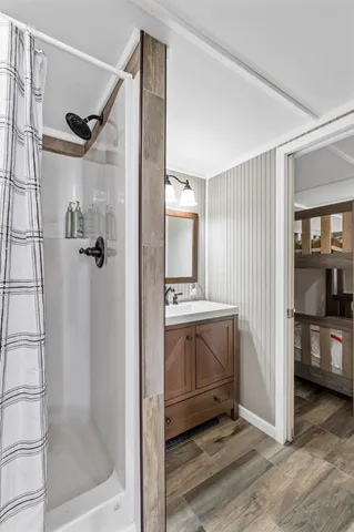 a bathroom with a shower and a sink