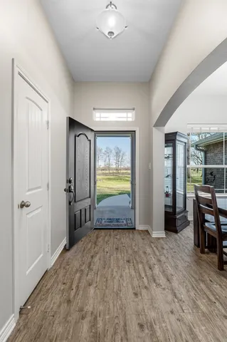 a view of empty room with wooden floor and furniture