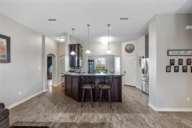 a large kitchen with a table and chairs