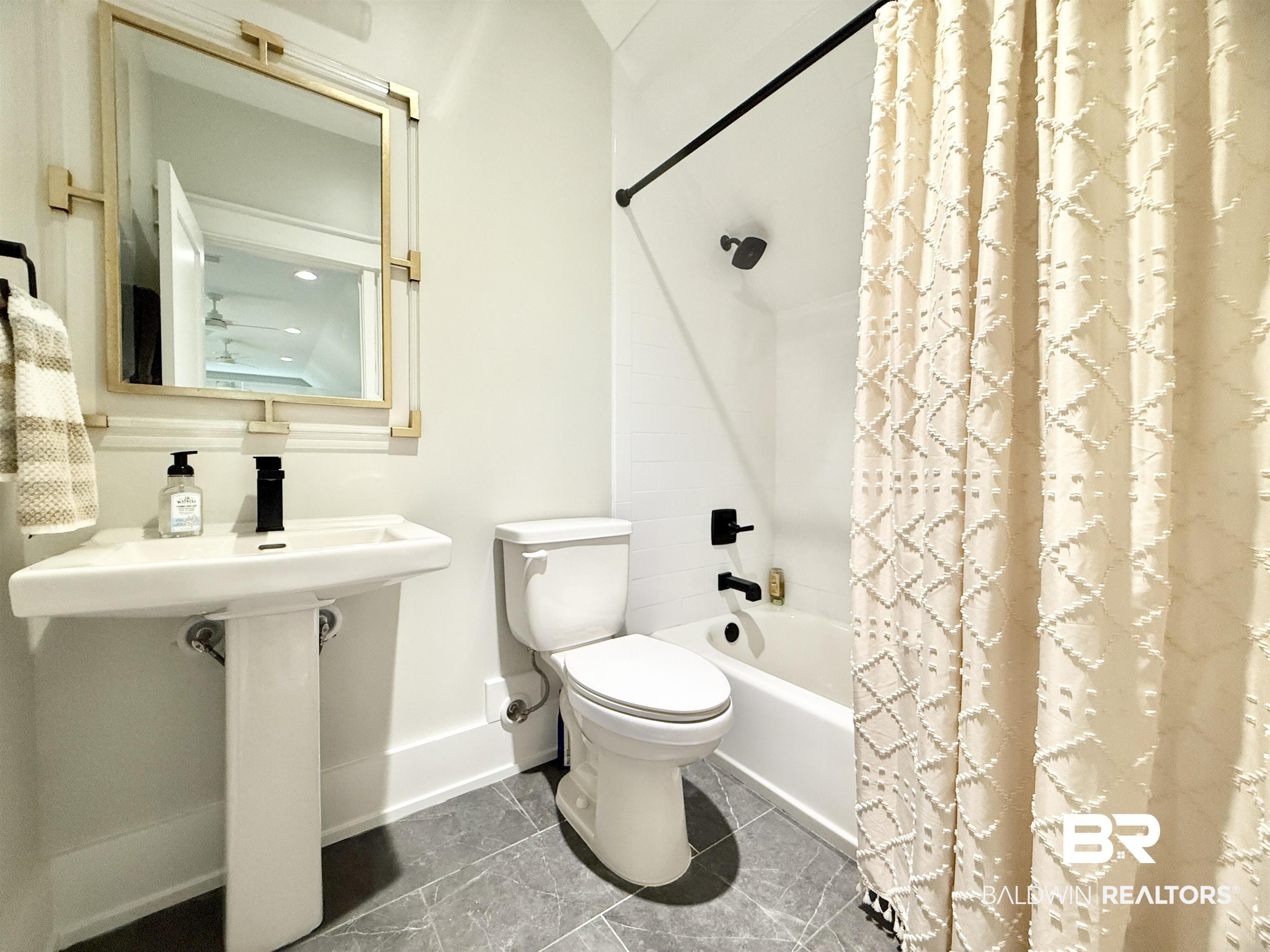 21767 Gallery Boulevard Fairhope, AL 36532 - Photo 51 of 74 Bathroom featuring toilet and shower / bath combination with curtain