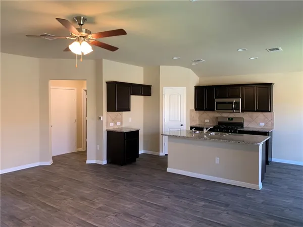 a kitchen with a sink and steel appliances