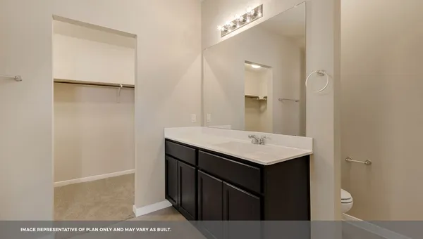 a bathroom with a sink mirror and vanity