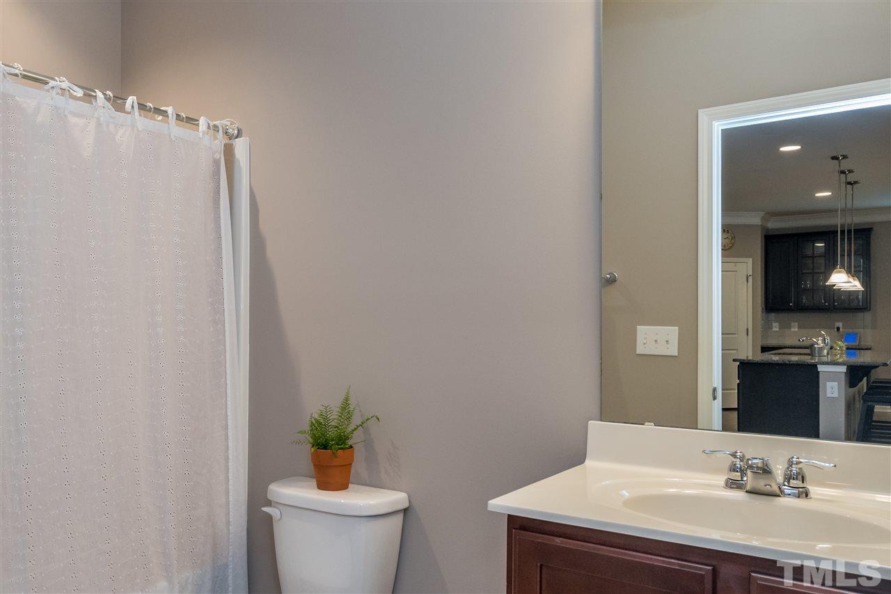 439 Plainview Avenue Raleigh, NC 27604 - Photo 10 of 29 a bathroom with a sink a toilet and shower curtain
