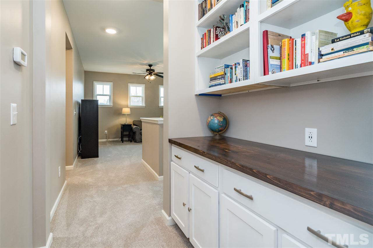 439 Plainview Avenue Raleigh, NC 27604 - Photo 15 of 29 a hallway with cabinets and chandelier