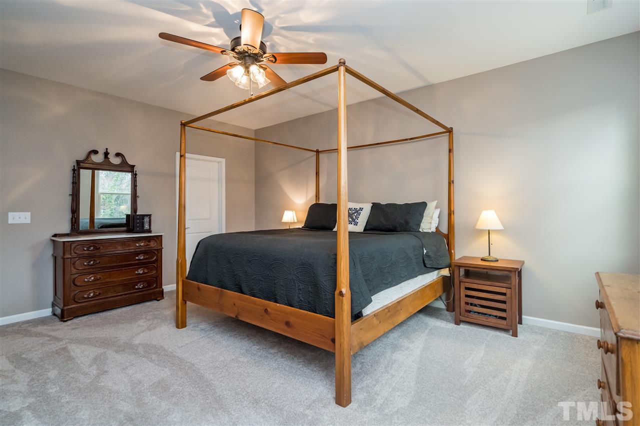 439 Plainview Avenue Raleigh, NC 27604 - Photo 17 of 29 a bedroom with a bed and a chandelier