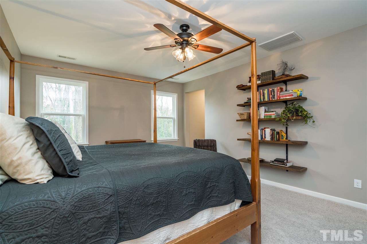 439 Plainview Avenue Raleigh, NC 27604 - Photo 18 of 29 a bedroom with a bed and a chandelier