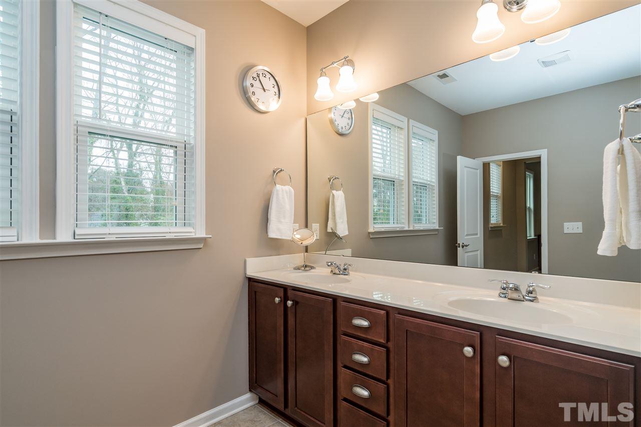 439 Plainview Avenue Raleigh, NC 27604 - Photo 19 of 29 a bathroom with a double vanity sink and a mirror