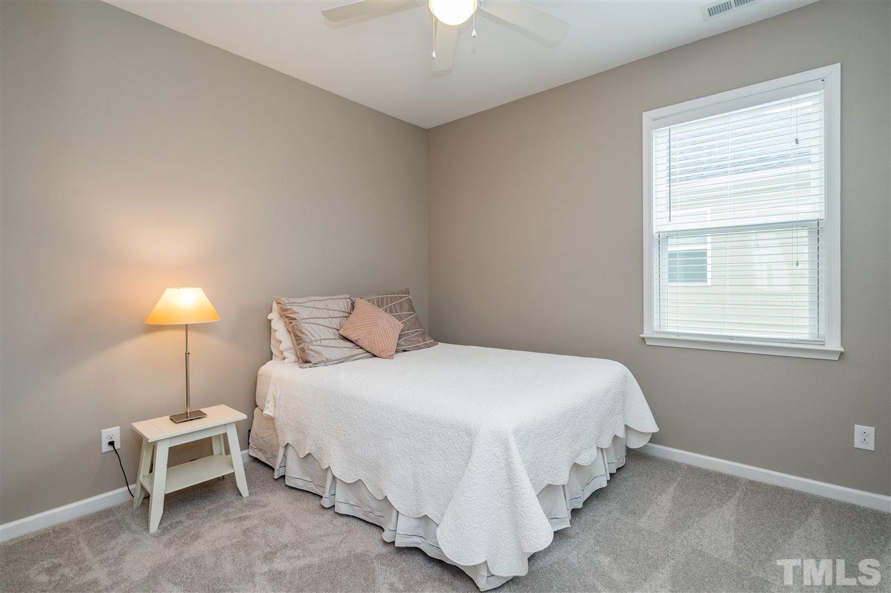 439 Plainview Avenue Raleigh, NC 27604 - Photo 22 of 29 a bedroom with a bed and a chandelier fan