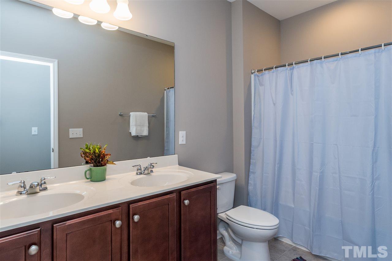 439 Plainview Avenue Raleigh, NC 27604 - Photo 23 of 29 a bathroom with a double vanity sink toilet and a mirror