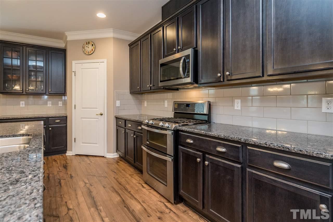 439 Plainview Avenue Raleigh, NC 27604 - Photo 6 of 29 a kitchen with stainless steel appliances granite countertop a stove microwave and refrigerator