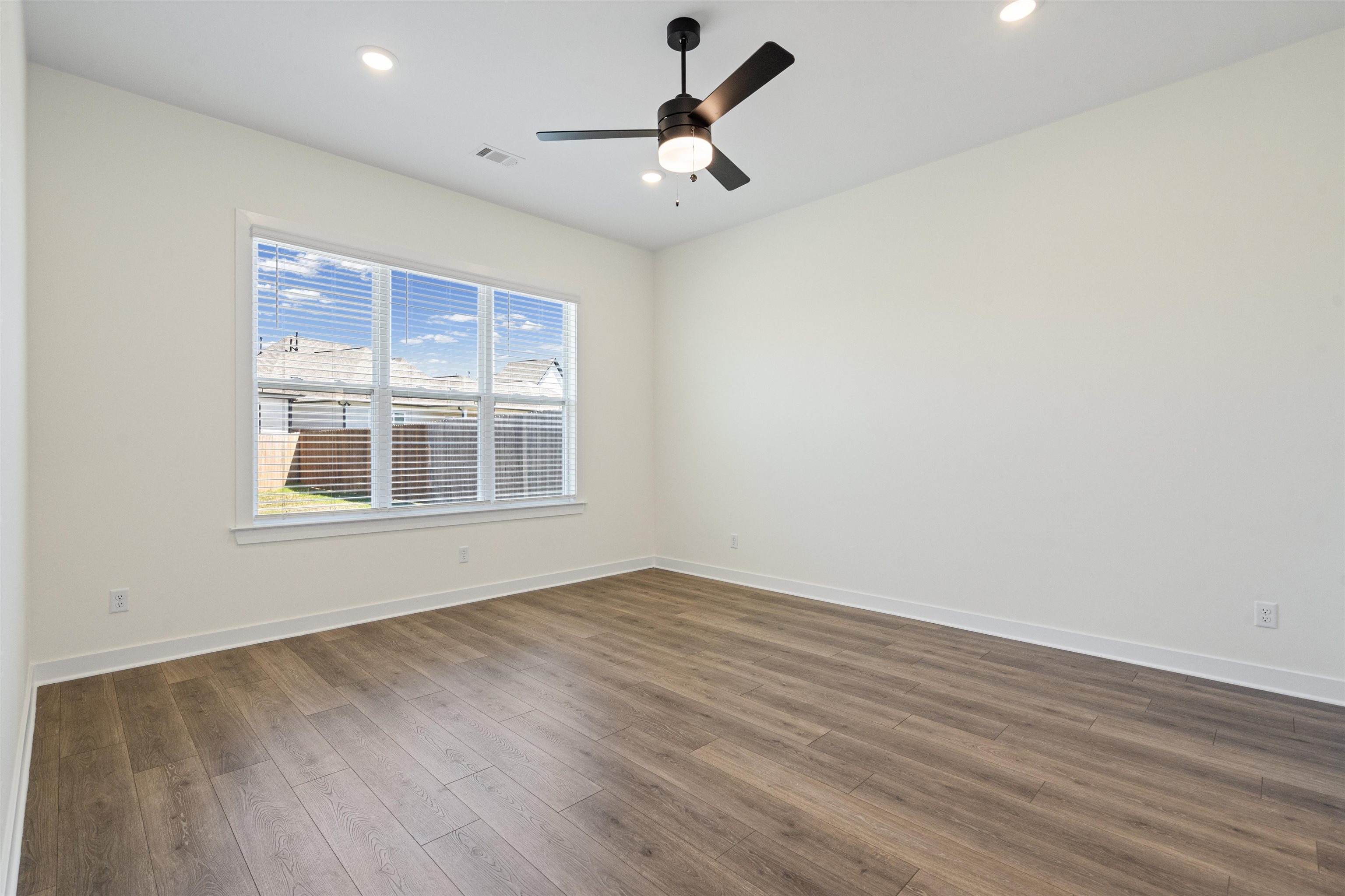 5666 Pleasant Pk Place Arlington, TN 38002 - Photo 18 of 27 Room featuring wood-finish flooring, a large window with blinds, recessed lighting, and a ceiling fan with light fixture
