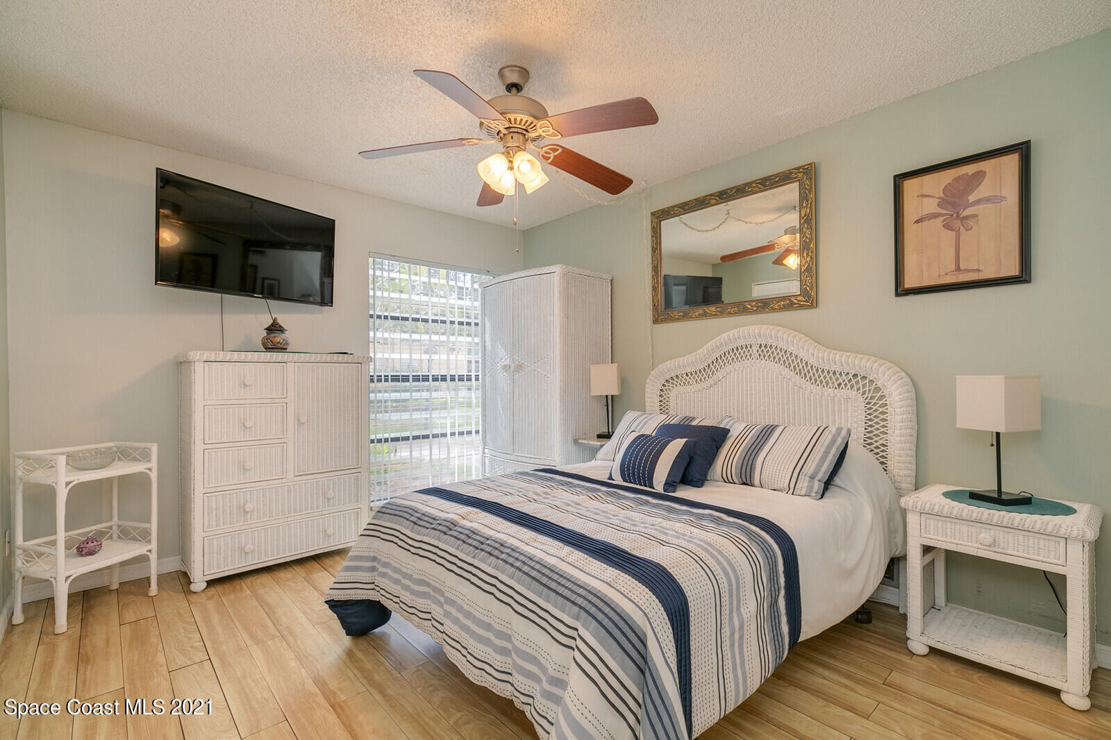 1225 North Wickham Road, Unit 416 Melbourne, FL 32935 - Photo 3 of 5 a bedroom with a bed and a flat screen tv
