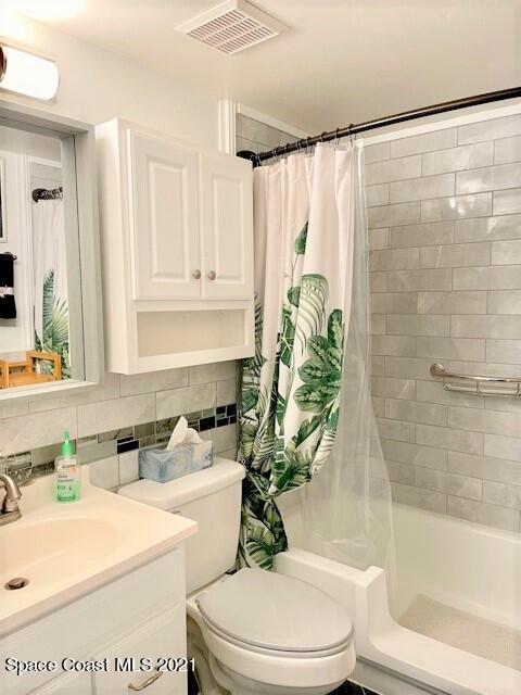 1225 North Wickham Road, Unit 416 Melbourne, FL 32935 - Photo 4 of 5 a bathroom with a sink a toilet and a bathtub