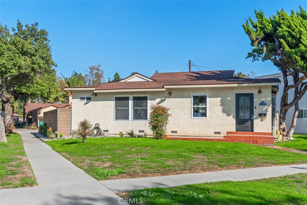 4769 East Malta Street Long Beach, CA 90815 - Photo 1 of 39 a front view of a house with garden and two chairs