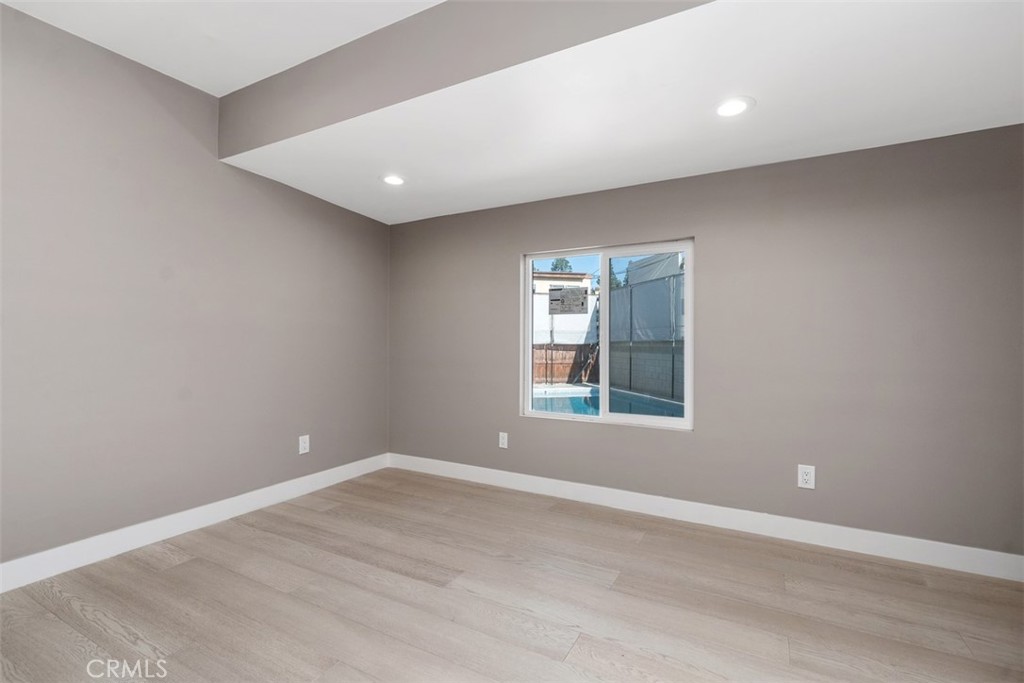 4769 East Malta Street Long Beach, CA 90815 - Photo 24 of 39 a view of empty room with wooden floor and fan