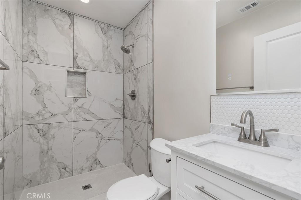 4769 East Malta Street Long Beach, CA 90815 - Photo 25 of 39 a bathroom with a sink toilet and shower