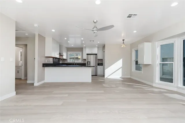 a view of kitchen with kitchen island and stainless steel appliances