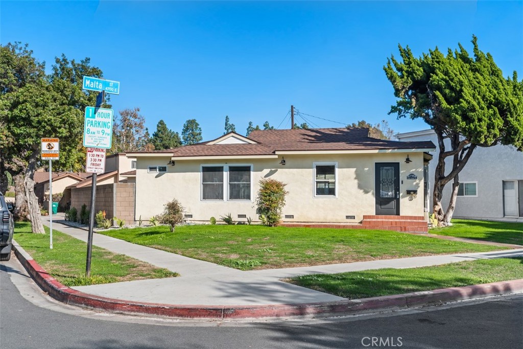 4769 East Malta Street Long Beach, CA 90815 - Photo 36 of 39 a front view of a house with a yard and garage