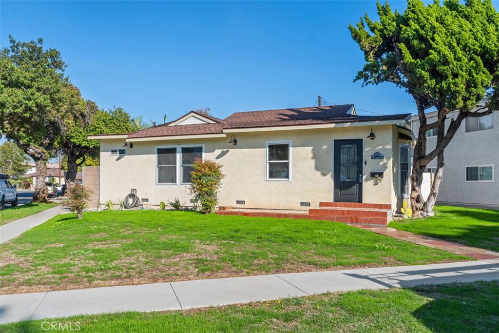 4769 East Malta Street Long Beach, CA 90815 - Photo 37 of 39 a front view of a house with a yard and garage