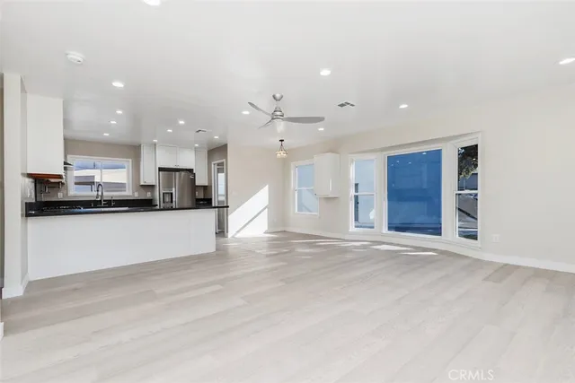 a view of kitchen with kitchen island and stainless steel appliances