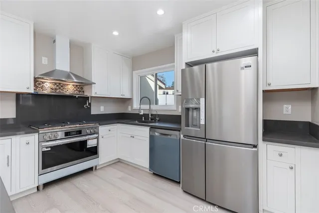 a kitchen with stainless steel appliances a refrigerator stove and microwave